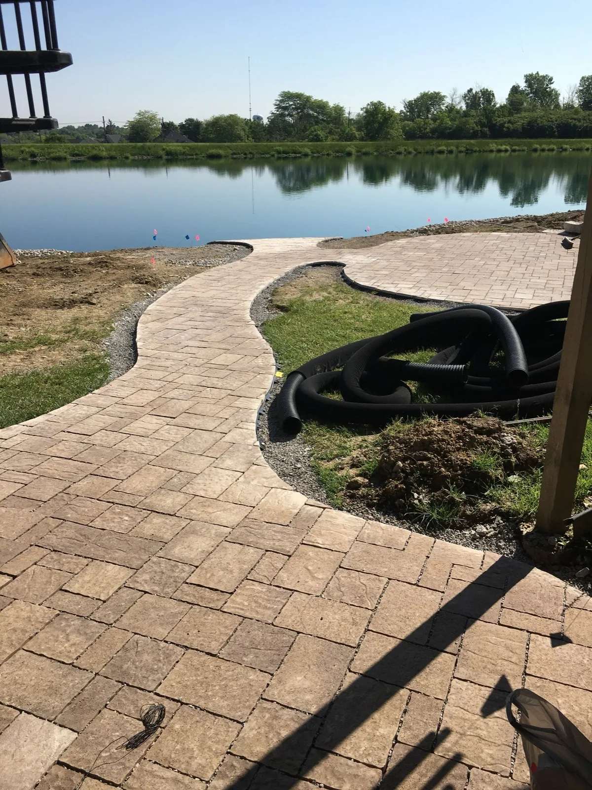 Curved paver walkway completed by Queen City Hardscapes