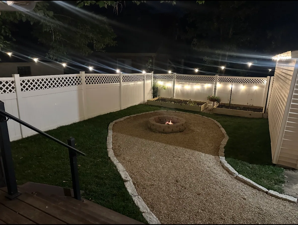 Fire-pit garden lighting completed by Queen City Hardscapes
